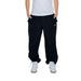 Karl Kani urban style clothing: man in white shirt and black Karl Kani Men Trousers