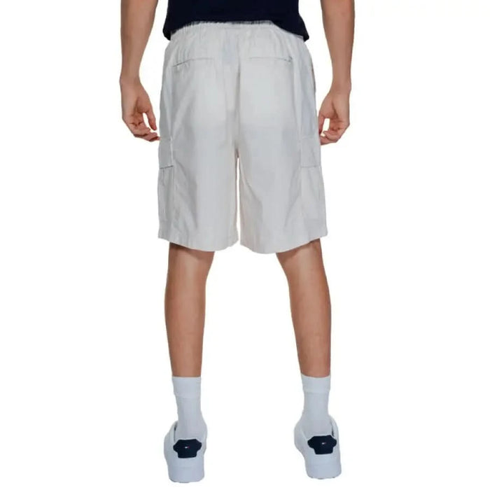 A man wearing white shorts and a black shirt from Jack & Jones Men Shorts