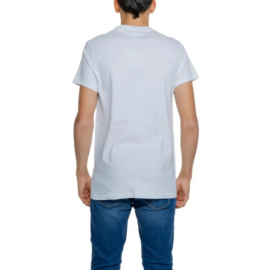 
                      
                        Man in Alviero Martini Prima Classe white t-shirt and jeans, stylish and casual
                      
                    