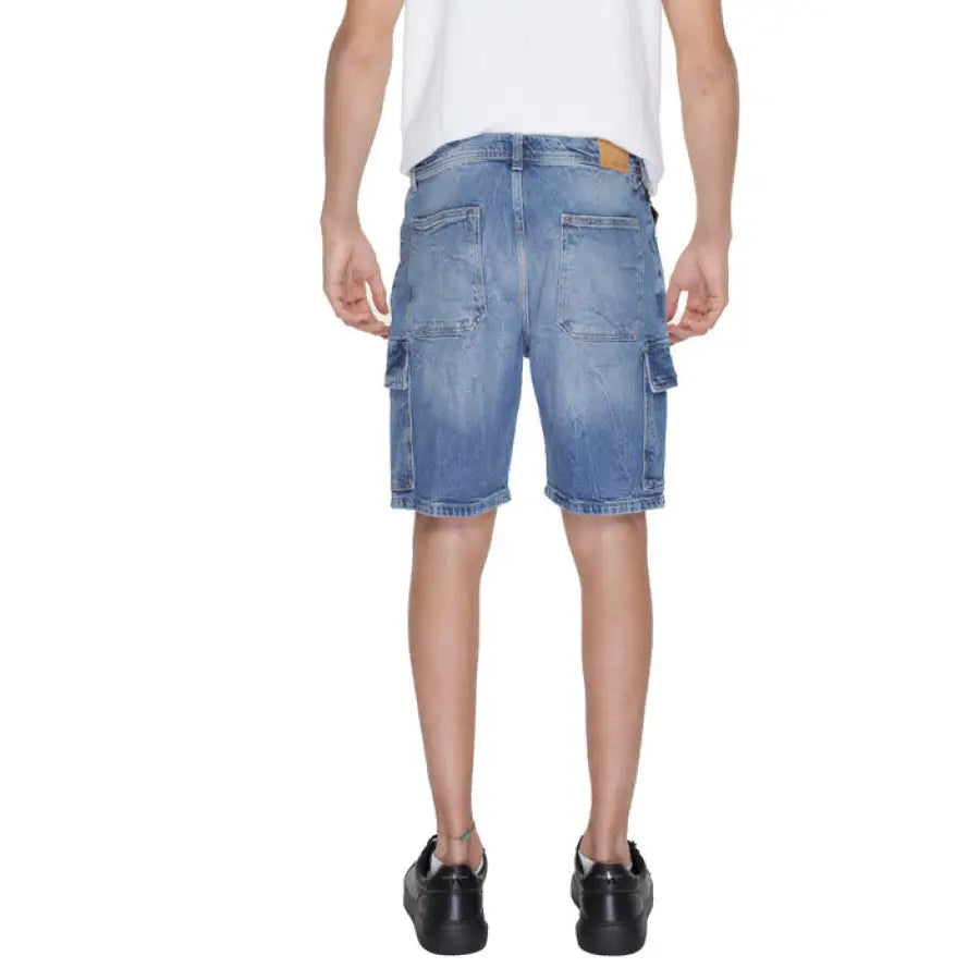 A man wearing a white t-shirt and Antony Morato Men Shorts in blue denim
