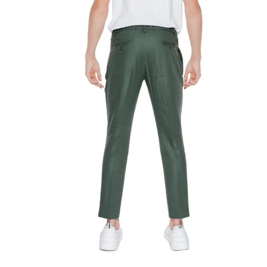 Man in white t-shirt with green Antony Morato trousers, stylish urban fashion