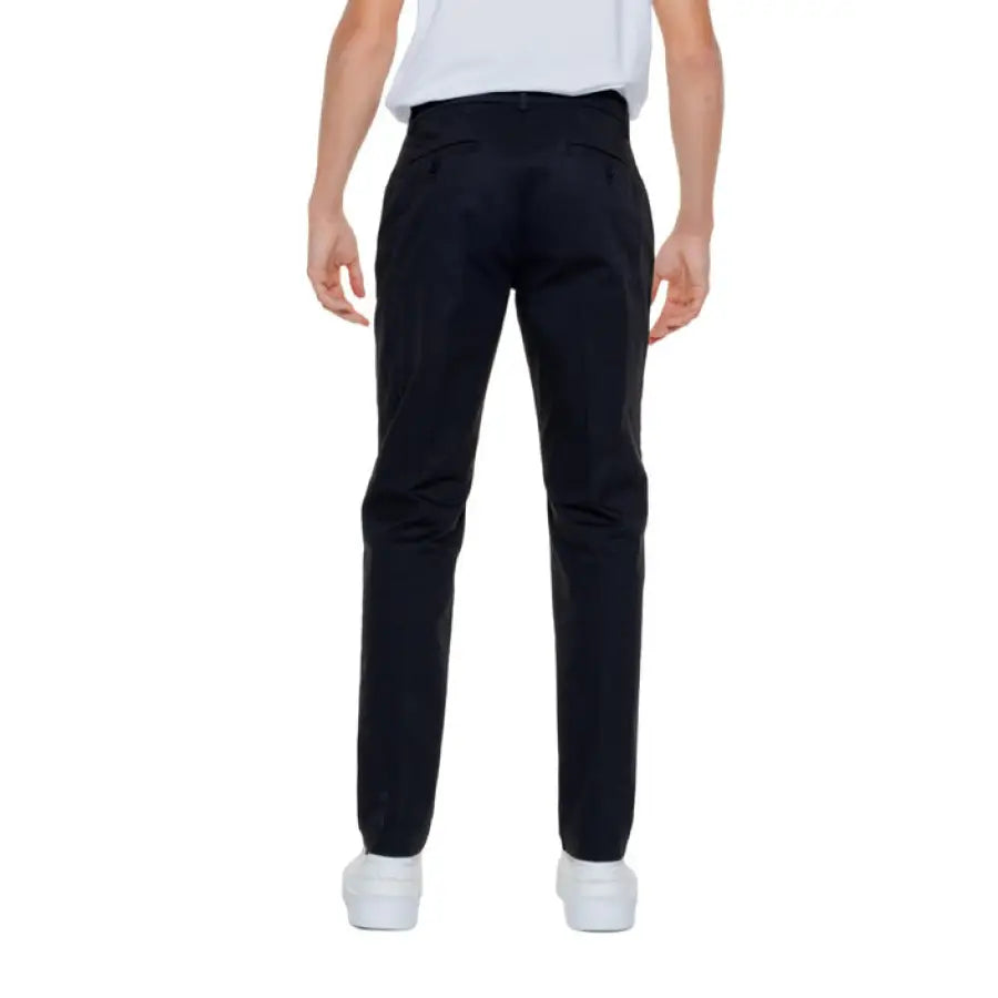 Man in white t-shirt and black pants from Antony Morato - urban men’s fashion trousers