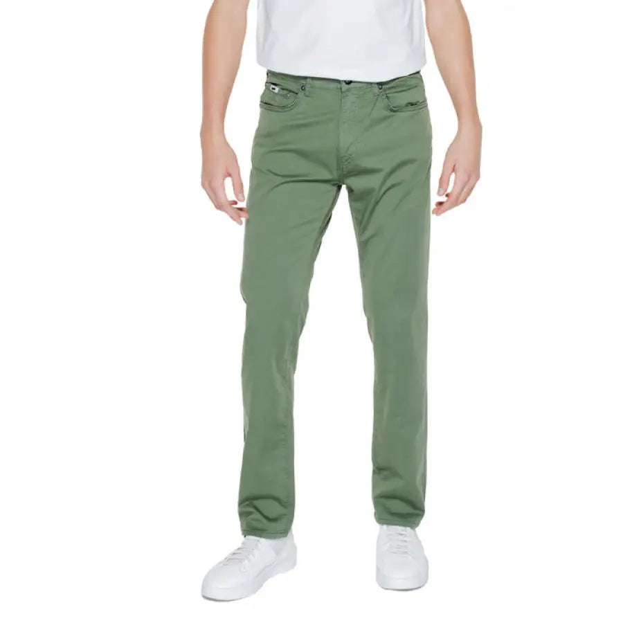 Urban style: Man in white t-shirt and green Gas-Gas Men Trousers, trendy clothing