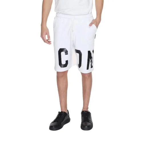 Man in white T-shirt and Icon Men Shorts showcasing urban city style fashion