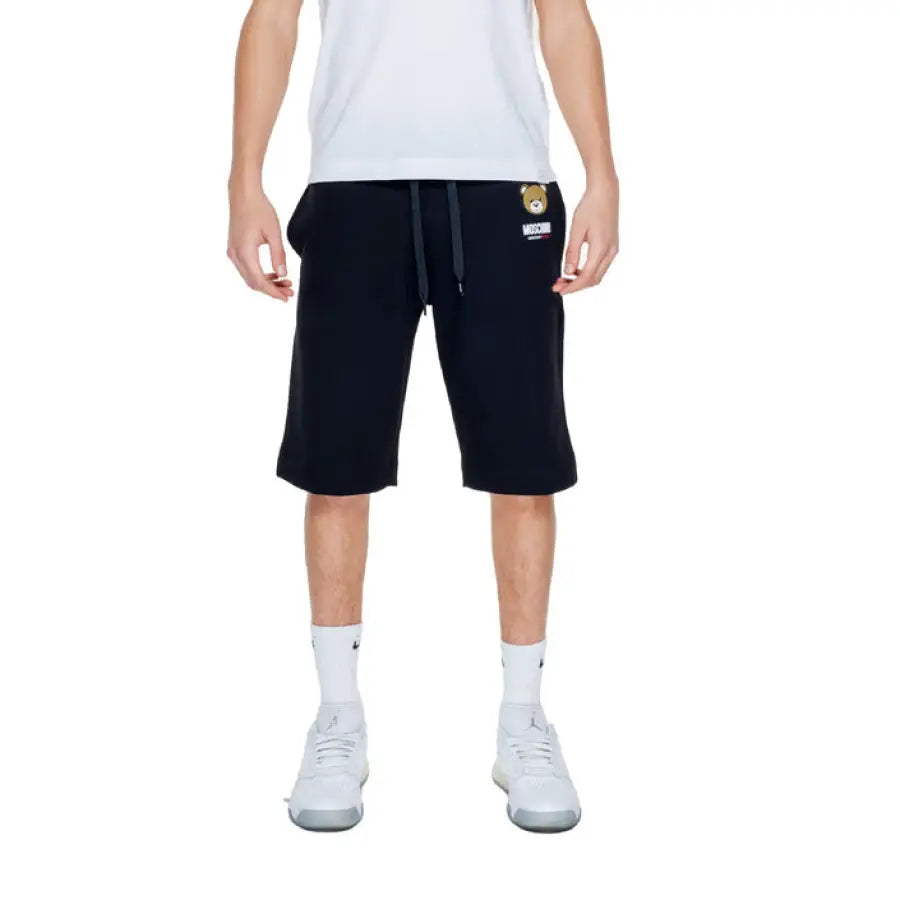 Man wearing a white t-shirt and black shorts from Moschino Underwear Men Collection