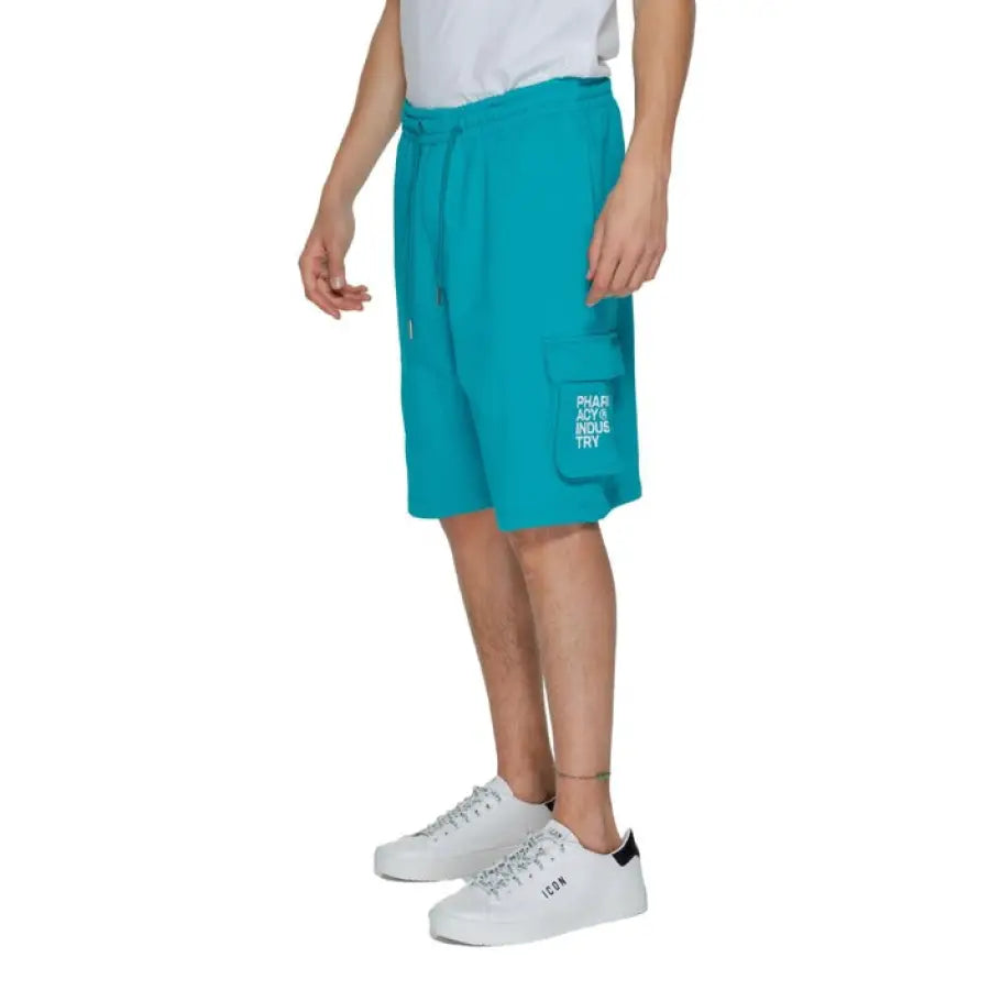 Man wearing white t-shirt and turquoise shorts - Pharmacy Men Shorts