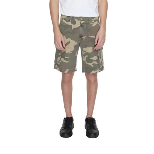 Man in U.S. Polo Assn. white tee and camo shorts showcasing urban city fashion