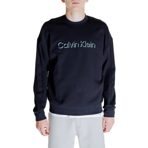 Navy blue Calvin Klein sweatshirt with light-colored logo text across the chest