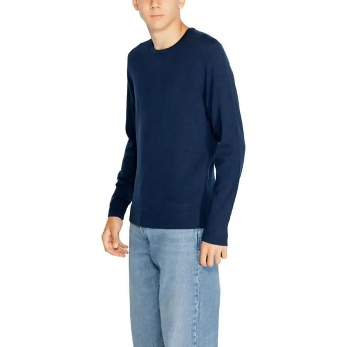 Navy blue long-sleeved sweater with light blue jeans from Calvin Klein Men Knitwear