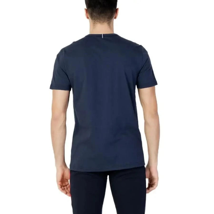 Le Coq Sportif Men T-Shirt in navy blue worn by a person viewed from behind