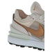 Nike Women Sneakers - Cream-colored upper and gold swoosh logo. Stylish and elegant