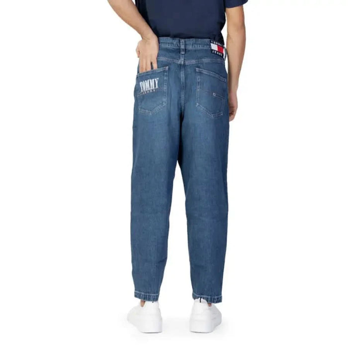 Baggy blue Tommy Hilfiger jeans featuring a logo patch on the back pocket