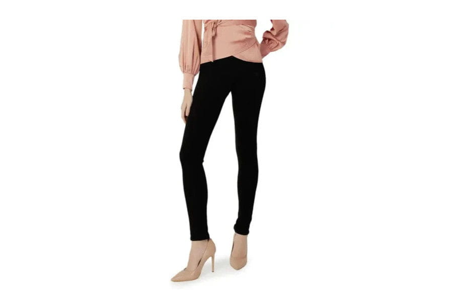 Pair of black skinny jeans with beige high heels for stylish minimalist outfits.