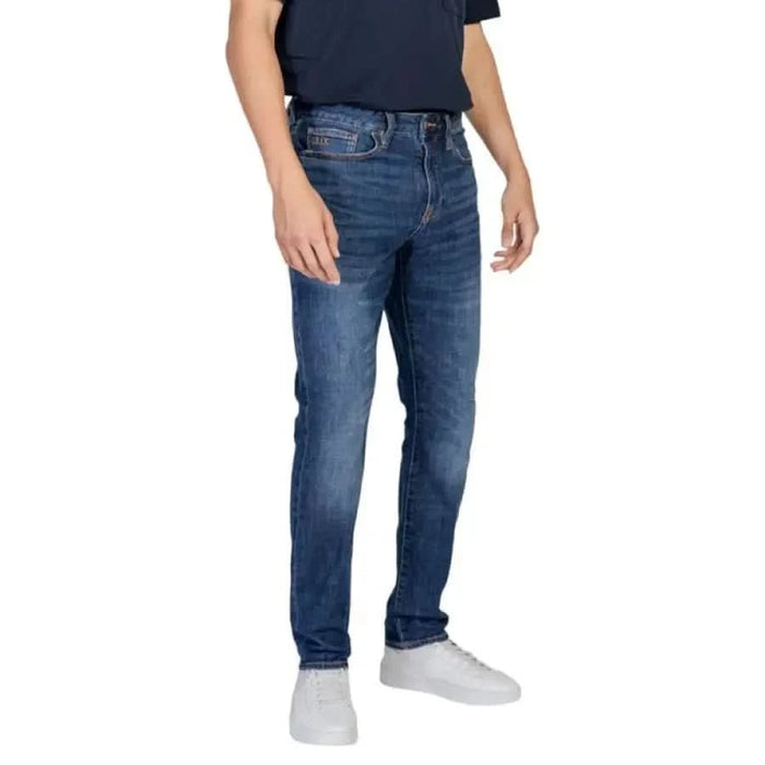 Men’s blue denim jeans worn by a model from Armani Exchange Trousers collection