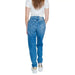 Calvin Klein blue denim jeans with white t-shirt and sneakers. Stylish outfit for women