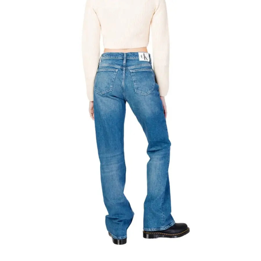 Calvin Klein Jeans - Women’s blue denim jeans paired with a white crop top. Elegant and stylish