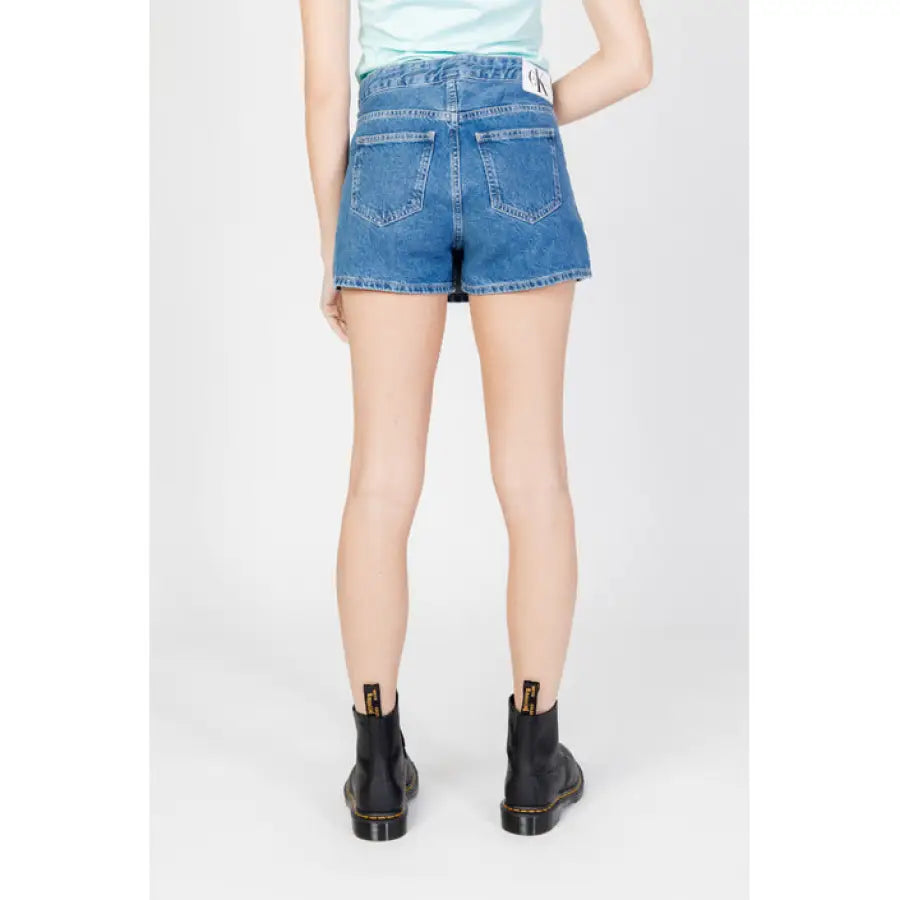
                      
                        Calvin Klein Jeans Women’s blue denim shorts paired with black ankle boots
                      
                    