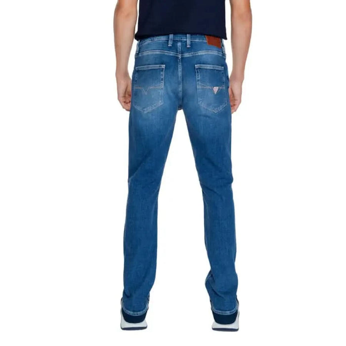 Pair of blue denim jeans displayed from the back in Guess Men Jeans collection