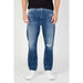 Blue Denim Tommy Hilfiger Jeans for Men featuring a distressed knee rip