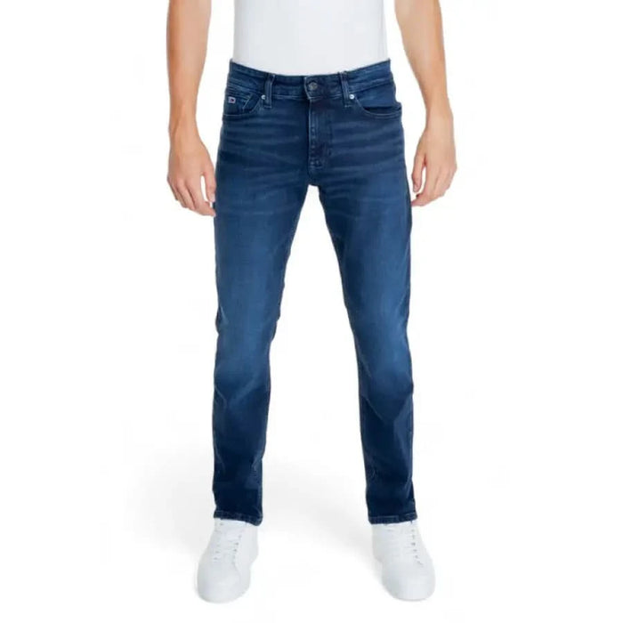 Blue denim jeans worn by a person, featuring Tommy Hilfiger branding