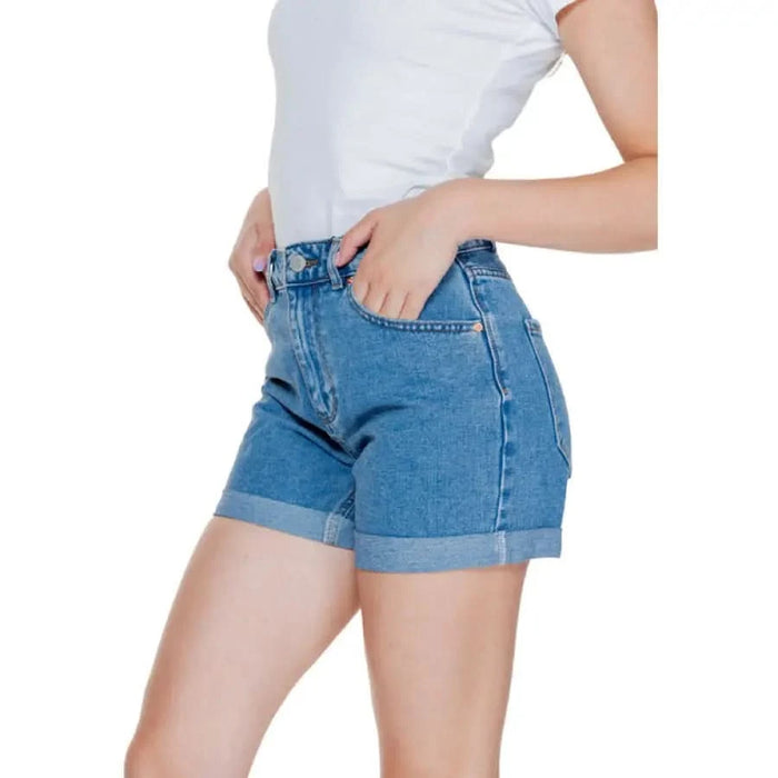 Blue denim shorts with rolled cuffs worn by a person in a white top - Vero Moda Women Short