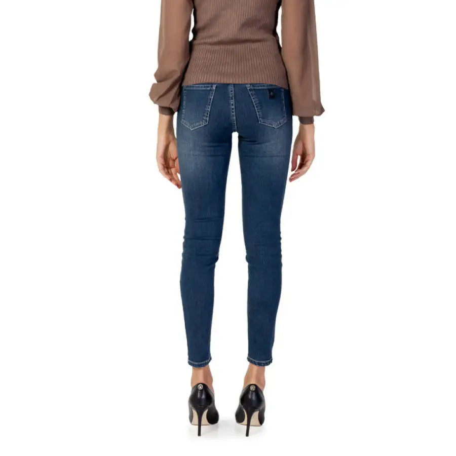
                      
                        Armani Exchange Women Jeans: Blue skinny jeans with brown sweater and black high heels
                      
                    