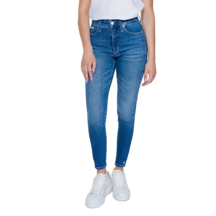 Blue skinny jeans with white sneakers and top, styled as Calvin Klein Women Jeans