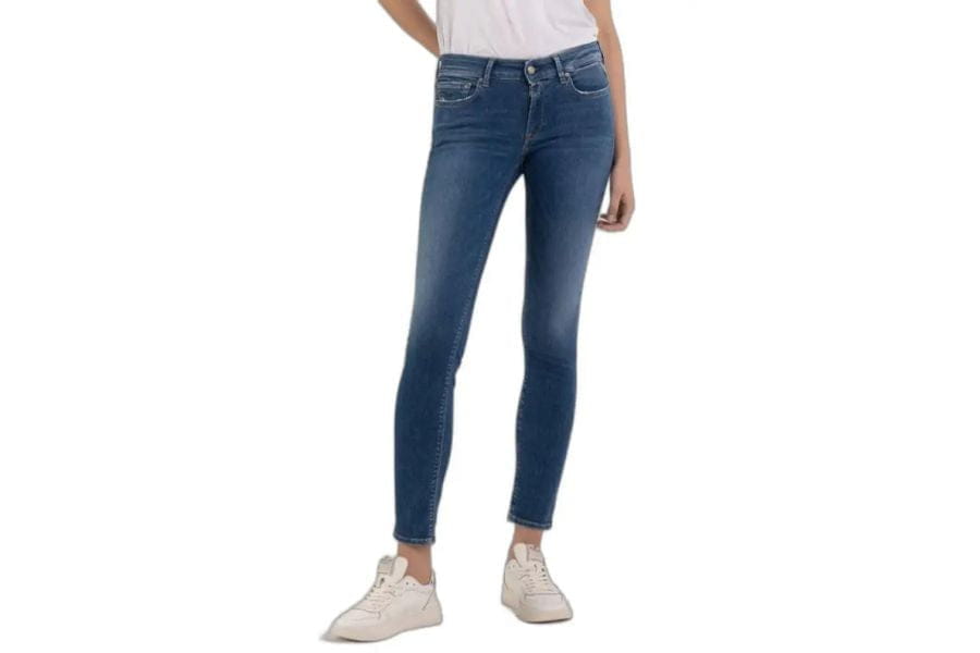 Blue skinny jeans worn by a person, perfect holiday outfit for a capsule wardrobe.