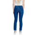 Street One Women’s Blue Skinny Jeans with Rolled Cuffs, White Top, and Gold Shoes