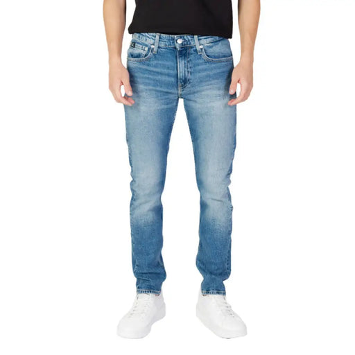 Light blue denim jeans worn by a model featuring Calvin Klein Jeans for men