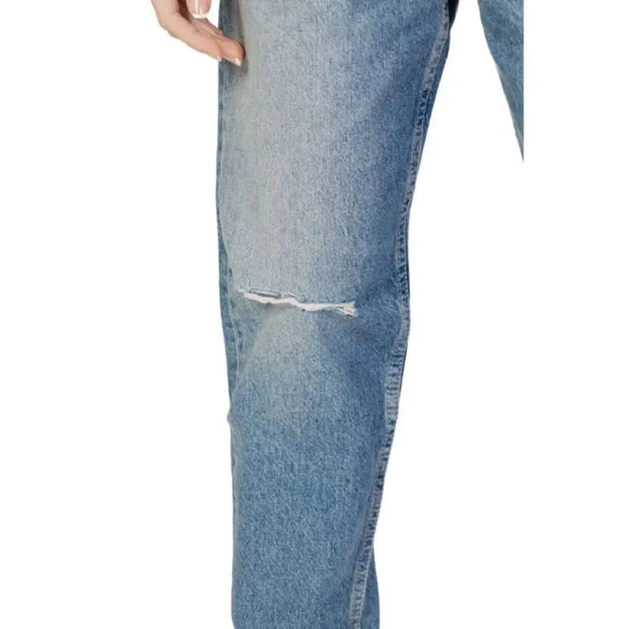 Calvin Klein light blue denim jeans with knee rip for women