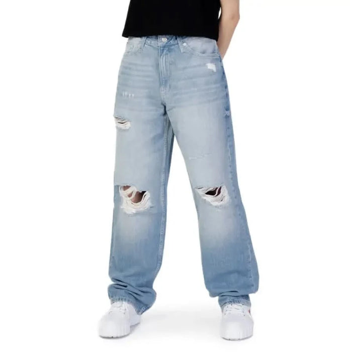 Calvin Klein light blue distressed baggy jeans with knee rips for women