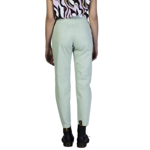 Light mint green Calvin Klein Jeans women’s trousers viewed from the back