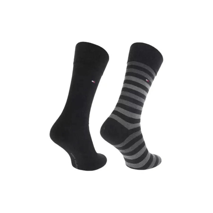 Tommy Hilfiger men’s dress socks, solid black and gray-striped, displayed on a beige background