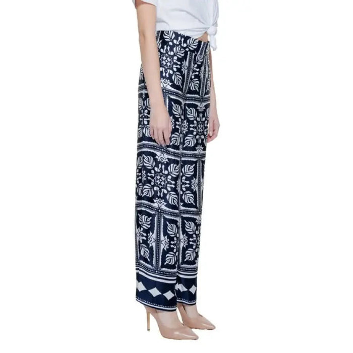 Patterned navy blue and white wide-leg palazzo pants with a leaf and floral design