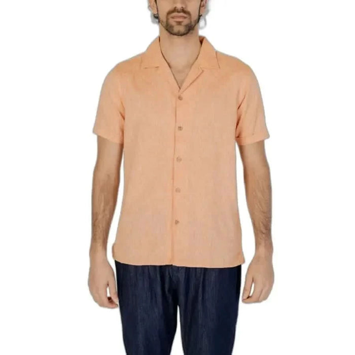 Peach short-sleeved button-up shirt for men by Hamaki-ho, paired with dark pants