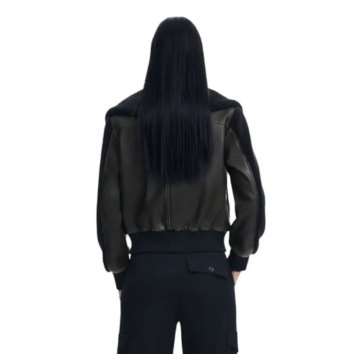 Person in black leather jacket viewed from behind, showcasing Desigual Women Jacket