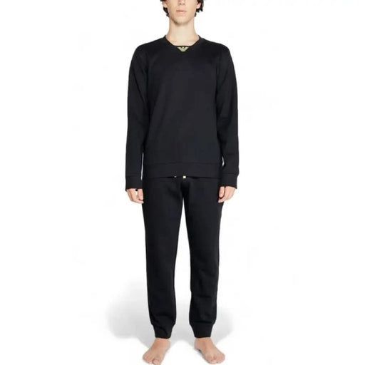 Person in black long-sleeved top and sweatpants, showcasing Emporio Armani Underwear