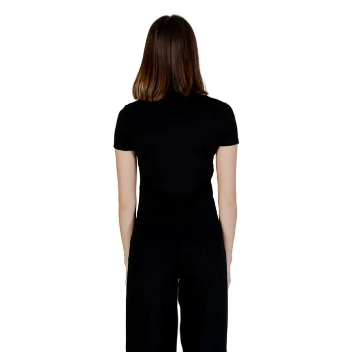 Person in black Ea7 Women T-Shirt and pants, presented from behind