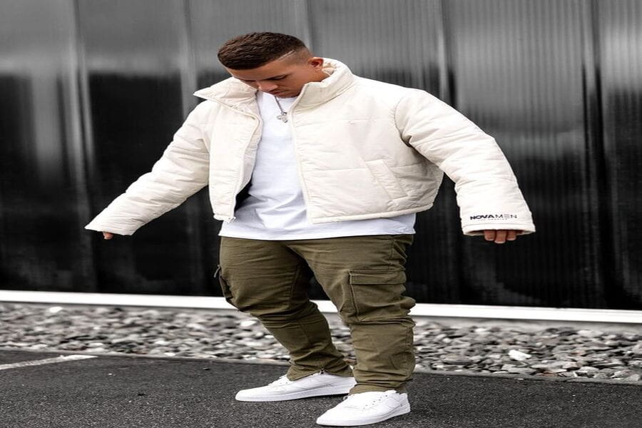 Person in a white puffer jacket, olive cargo pants, and white sneakers outfit.