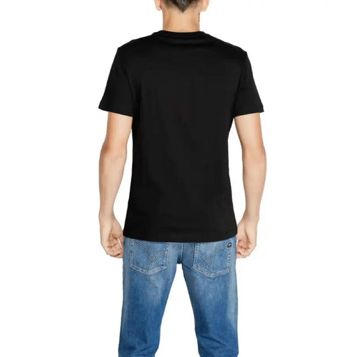 Antony Morato Men T-Shirt in plain black worn with blue jeans by a model