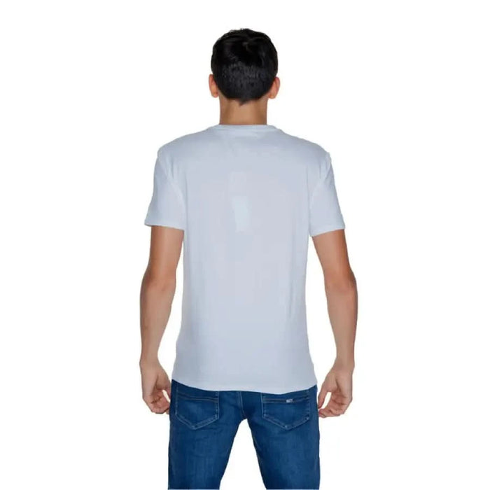 Back view of a person wearing Guess Men T-Shirt in plain white color