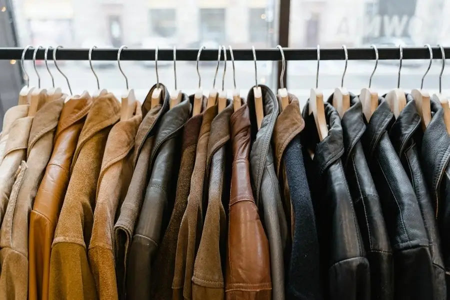 Rack of leather jackets in brown and black showcasing retro fashion styles.