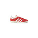 Red Adidas Gazelle sneaker featuring white stripes and sole in Adidas Men Sneakers collection