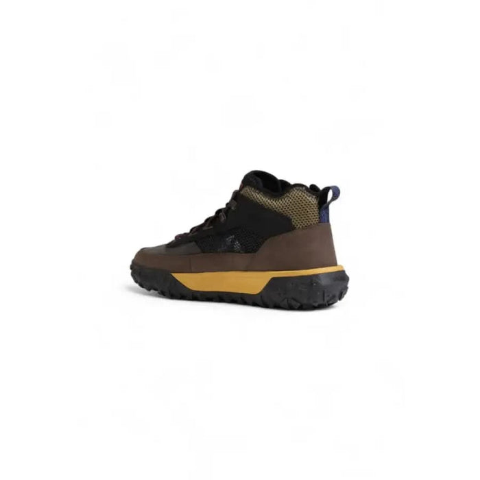 Rugged Timberland men sneakers featuring a brown upper and yellow midsole for hiking