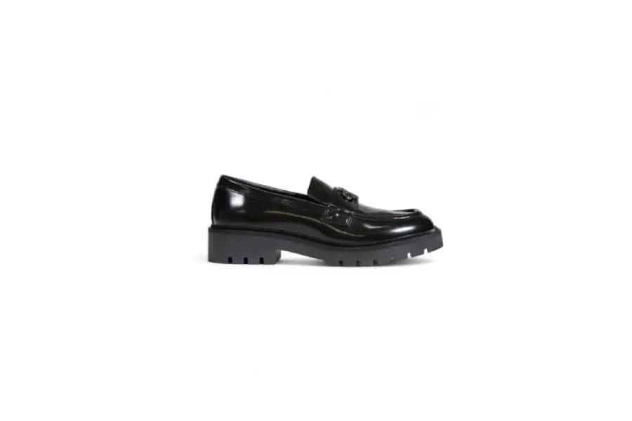 Shiny black leather loafer with chunky sole, ideal for chic summer work outfits.