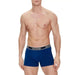 Shirtless male torso wearing blue Hilfiger boxer briefs Tommy Hilfiger Men Underwear