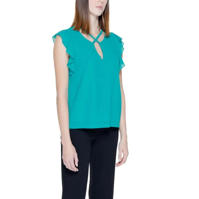 Sleeveless turquoise blouse with ruffled edges by Rinascimento featuring a keyhole neckline