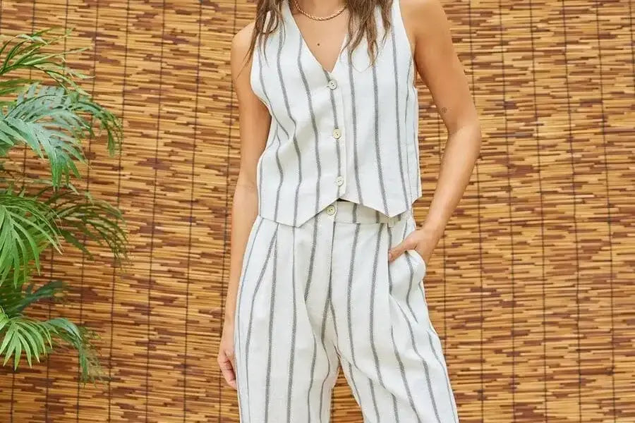 Sleeveless white gray striped jumpsuit, perfect outfit for holiday capsule wardrobe.