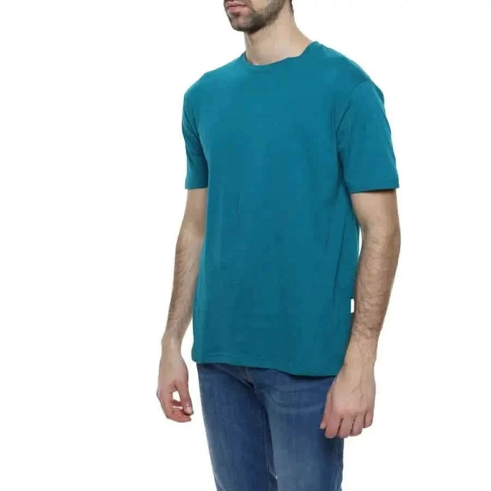 Gianni Lupo Men T-Shirt in teal shown on a person wearing blue jeans